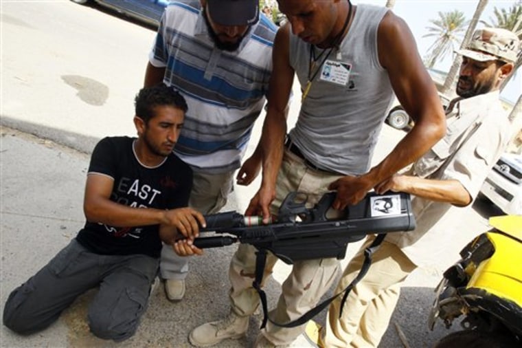 Libyan rebels show a FN F2000 assault rifle with  grenade launcher they found after surrounding a building to findweapons provided by ousted Libya leader Moammar Gadhafi to the population in Tripoli, Libya, Monday, Sept. 5, 2011. Negotiations over the surrender of one of Moammar Gadhafi's remaining strongholds have collapsed, and Libyan rebels were waiting for orders to launch their final attack on the besieged town of Bani Walid, a spokesman said. (AP Photo/Francois Mori)
